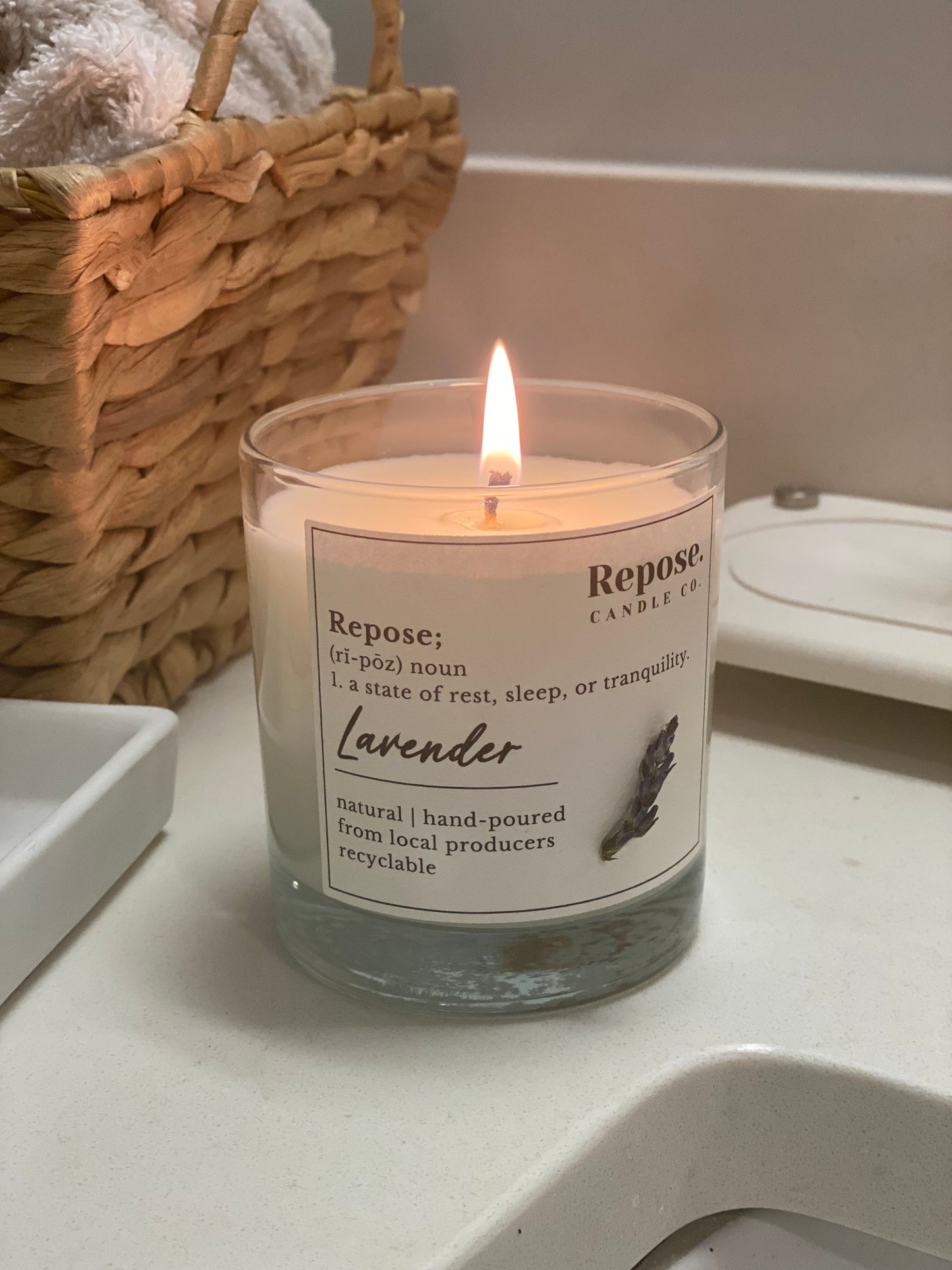A lit lavender candle in the bathroom.