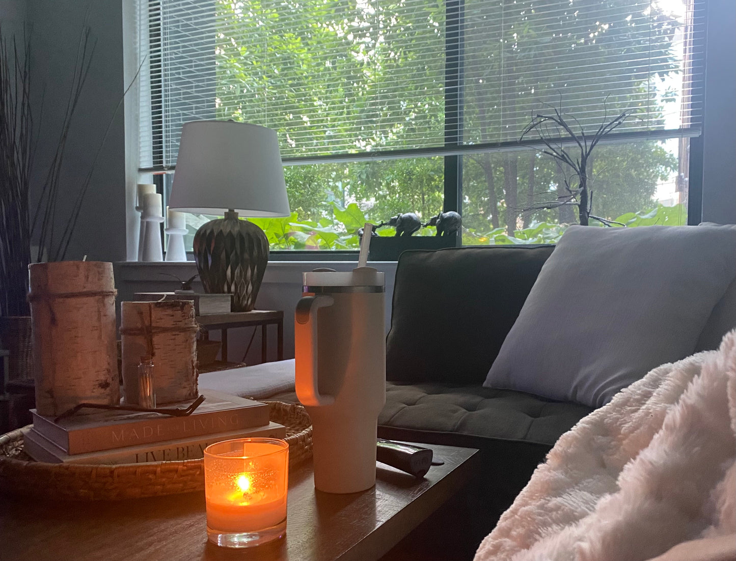A living room scene with a candle burning.