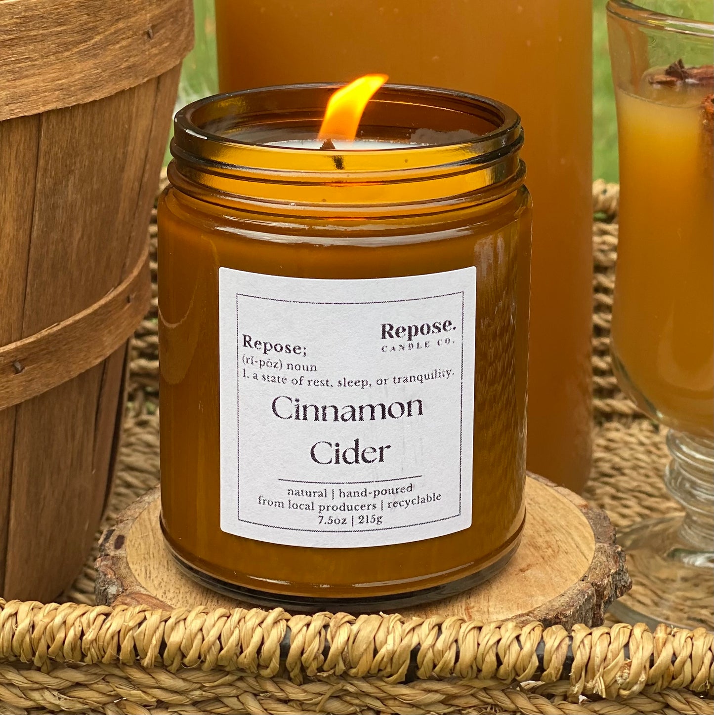 A lit Cinnamon Cider Candle.